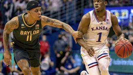 Baylor Bears guard James Akinjo (left) attempts to defend Kansas Jayhawks guard Joseph Yesufu during a Big 12 basketball game