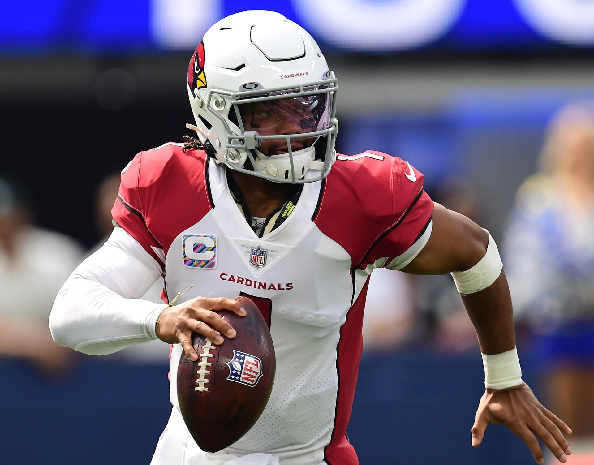 Arizona Cardinals quarterback Kyler Murray rolls out to pass