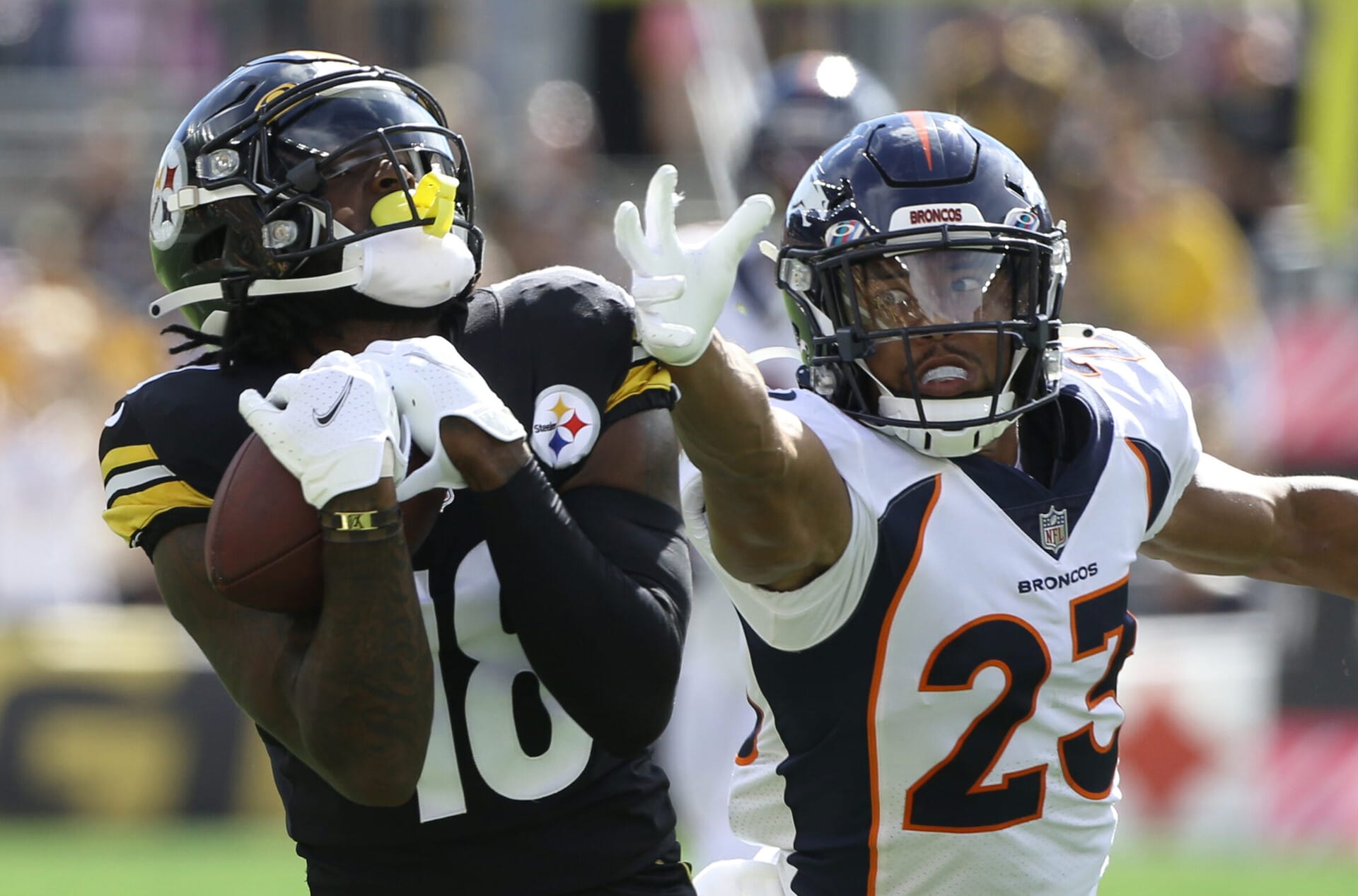 Pittsburgh Steelers wide receiver Diontae Johnson makes a catch while being defended by Denver Broncos cornerback Kyle Fuller